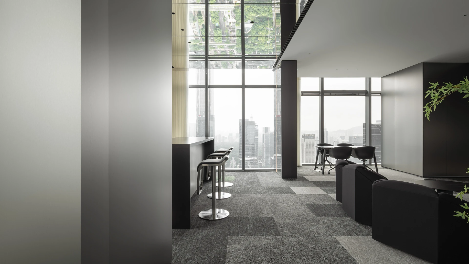 Modern office space with large windows and city view, featuring gray commercial carpet tiles in a checkerboard pattern