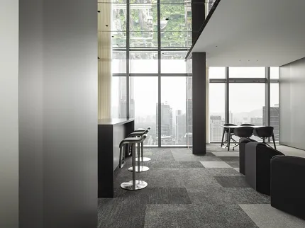 Contemporary office interior with gray commercial carpet tiles and panoramic cityscape view Modern office space with large windows and city view, featuring gray commercial carpet tiles in a checkerboard pattern