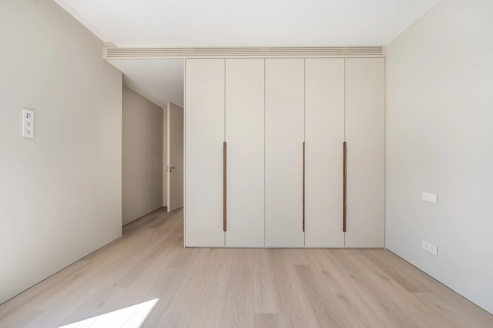 Modern dressing with white cabinets and light wooden Coretec floor