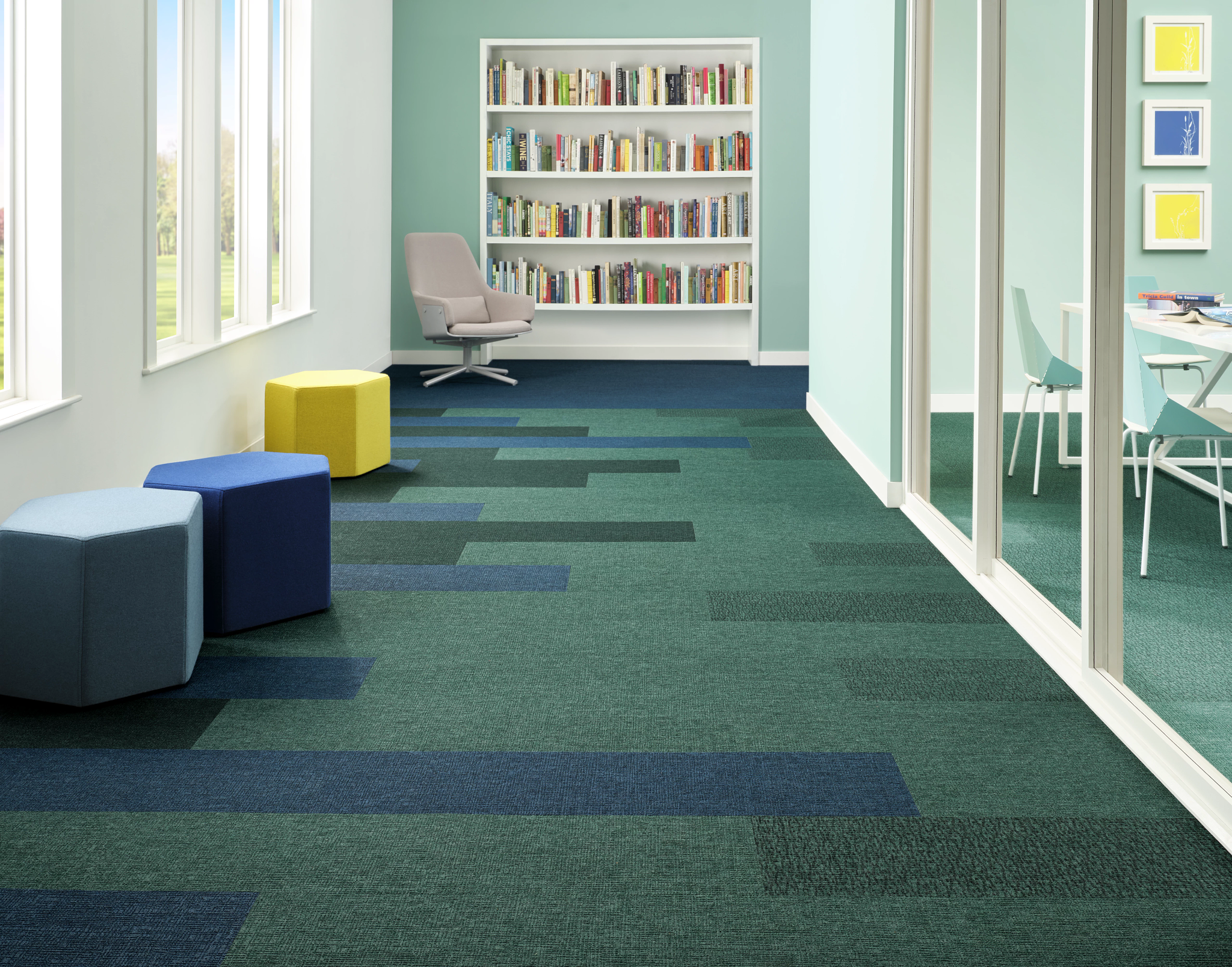 
  "Modern office space with green and blue carpet tiles, 48x12 inch dimensions, featuring a bookshelf and seating area"
)