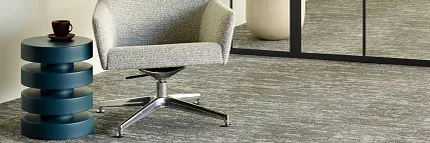 Gray Commercial Carpet Tile in Modern Office Space Modern office space with gray commercial carpet tile, featuring a contemporary chair and side table