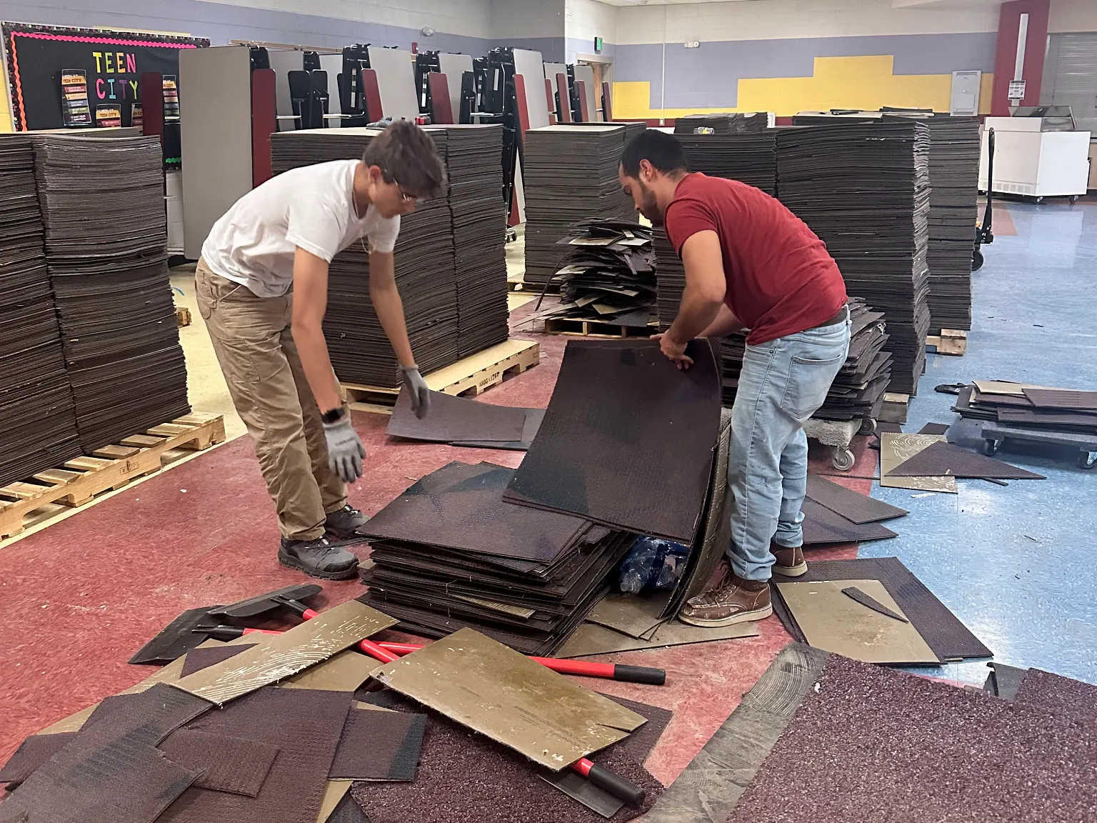 Installars picking up old ecoworx carpet tile