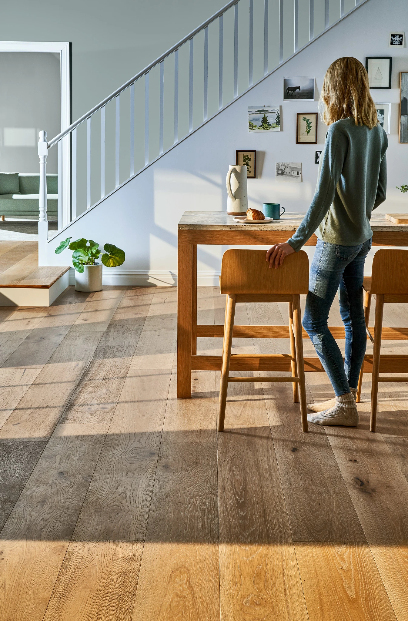 woman standing at a table in a living room area