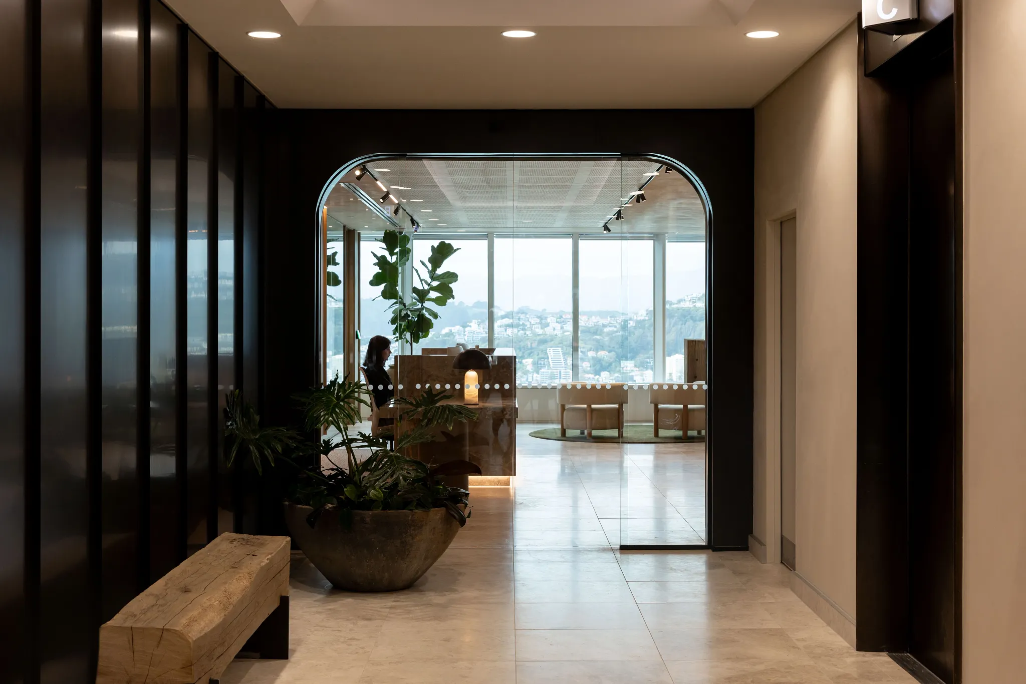 Modern office lobby with large windows and stone flooring