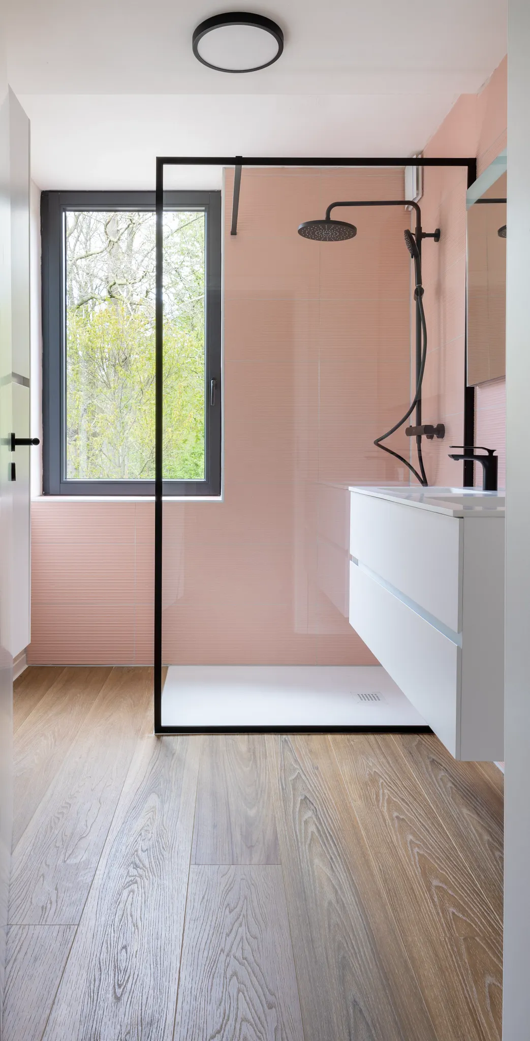Bathroom with shower and dark wooden floor 