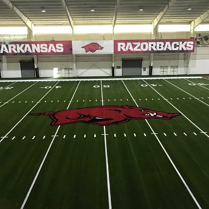 Arkansas Razorbacks artificial turf indoor sports facility Indoor sports facility with artificial turf featuring Arkansas Razorbacks logo