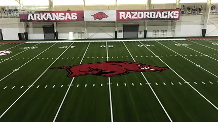Arkansas Razorbacks artificial turf indoor sports facility Indoor sports facility with artificial turf featuring Arkansas Razorbacks logo