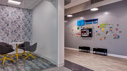 Contemporary Workplace Design with Carpet and Wood Flooring Modern workplace interior with glass-walled meeting room, featuring grey and blue carpet tiles and light wood flooring