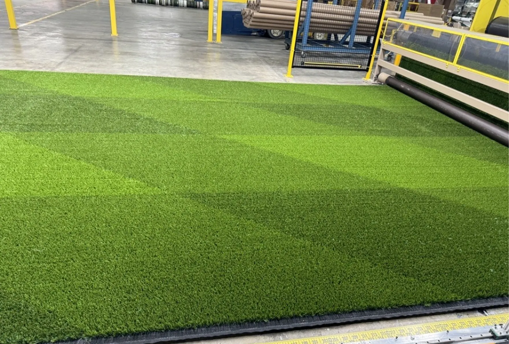 Green artificial turf in manufacturing facility