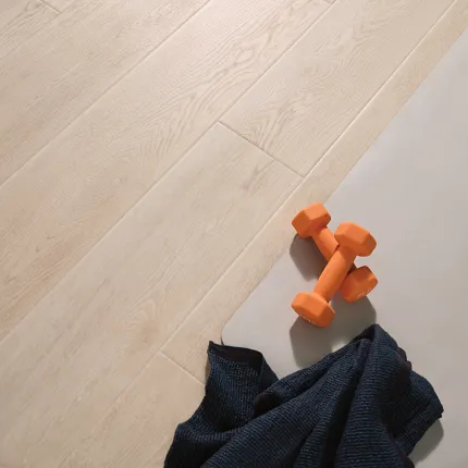 Light Wood Look Vinyl Flooring - Coretec Residential SPC 49x7.13 inch Light wood look vinyl flooring with orange dumbbells and a dark towel, 49x7.13 inch Coretec Residential SPC construction