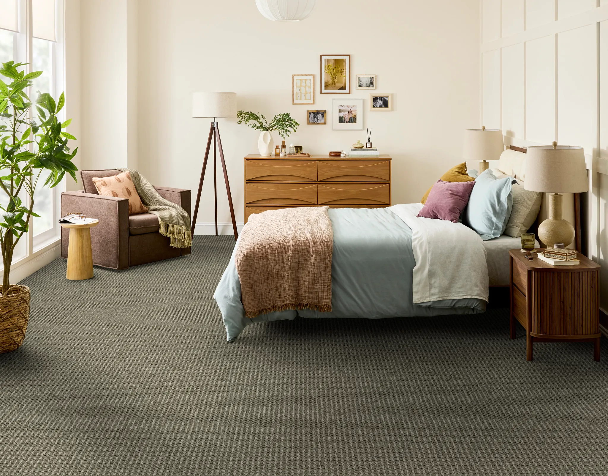 Cozy living room with a plush cream armchair and a wooden side table on a textured blue carpet