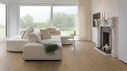 Beige Luxury Vinyl Plank Flooring in Modern Living Room Scene Modern living room with beige luxury vinyl plank flooring, white sectional sofa, and large windows overlooking a green landscape