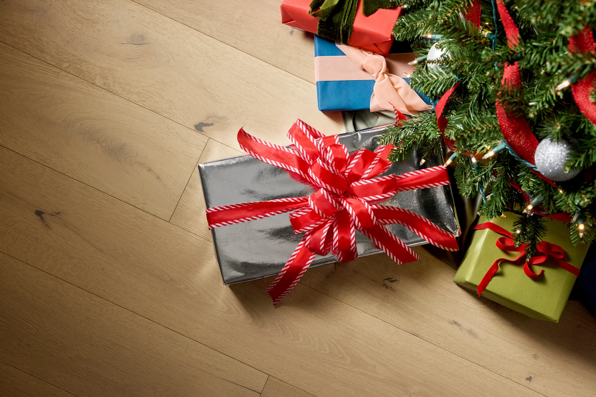 Hardwood flooring with Christmas gifts under a tree