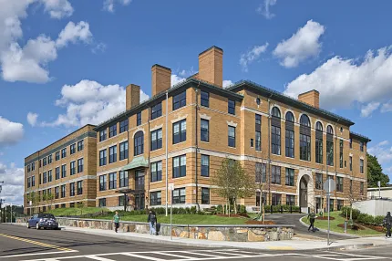 Architectural design of a modern brick building Exterior view of a large brick building under a blue sky