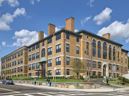 Architectural design of a modern brick building Exterior view of a large brick building under a blue sky