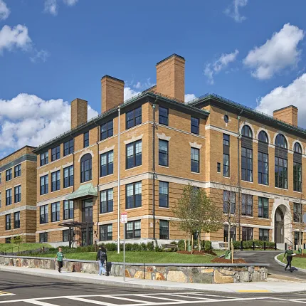 Architectural design of a modern brick building Exterior view of a large brick building under a blue sky