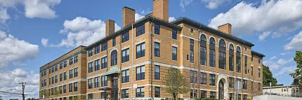 Architectural design of a modern brick building Exterior view of a large brick building under a blue sky