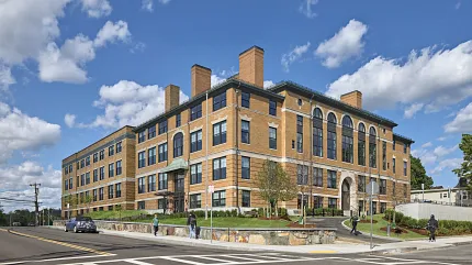 Architectural design of a modern brick building Exterior view of a large brick building under a blue sky
