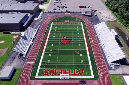 Artificial Turf Football Field with Red Hawks and Athens Logos Aerial view of a football field with artificial turf featuring "Red Hawks" and "Athens" logos