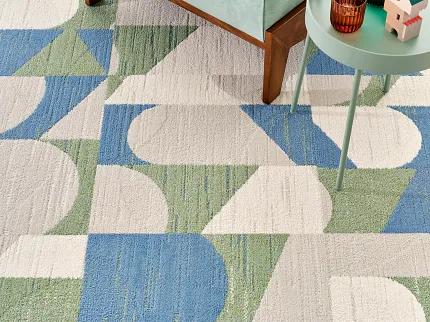 Modern geometric carpet design in blue, green, and beige with furniture accents Josef in Fresco
