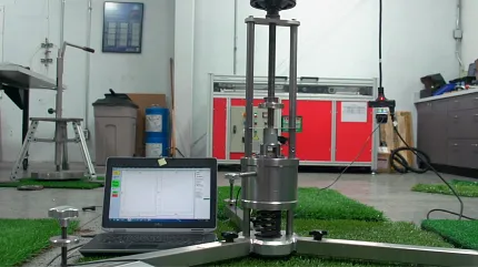 Advanced laboratory testing for artificial turf quality Testing equipment on artificial grass in a laboratory setting