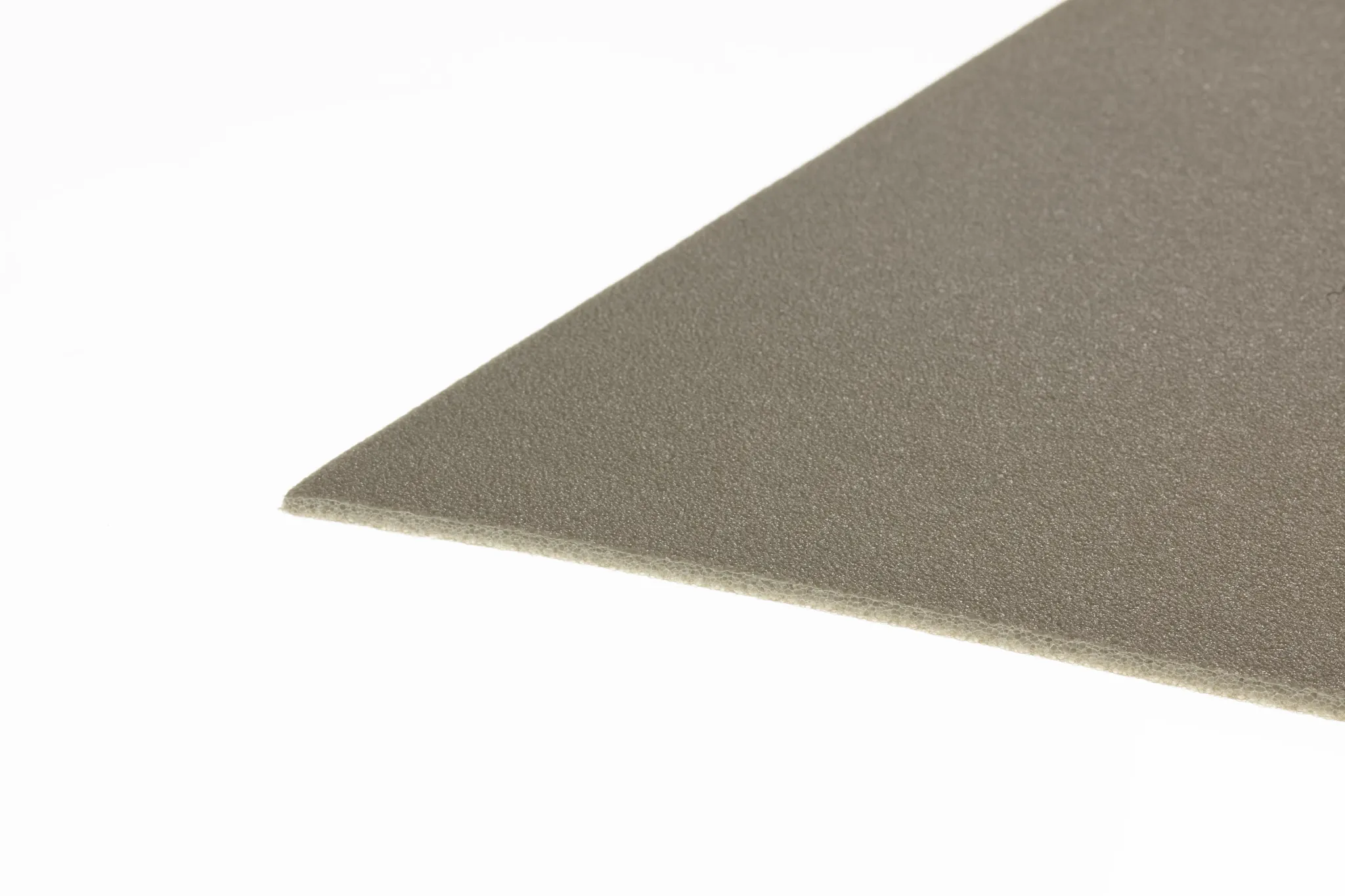Close-up of a beige flooring swatch with a textured surface