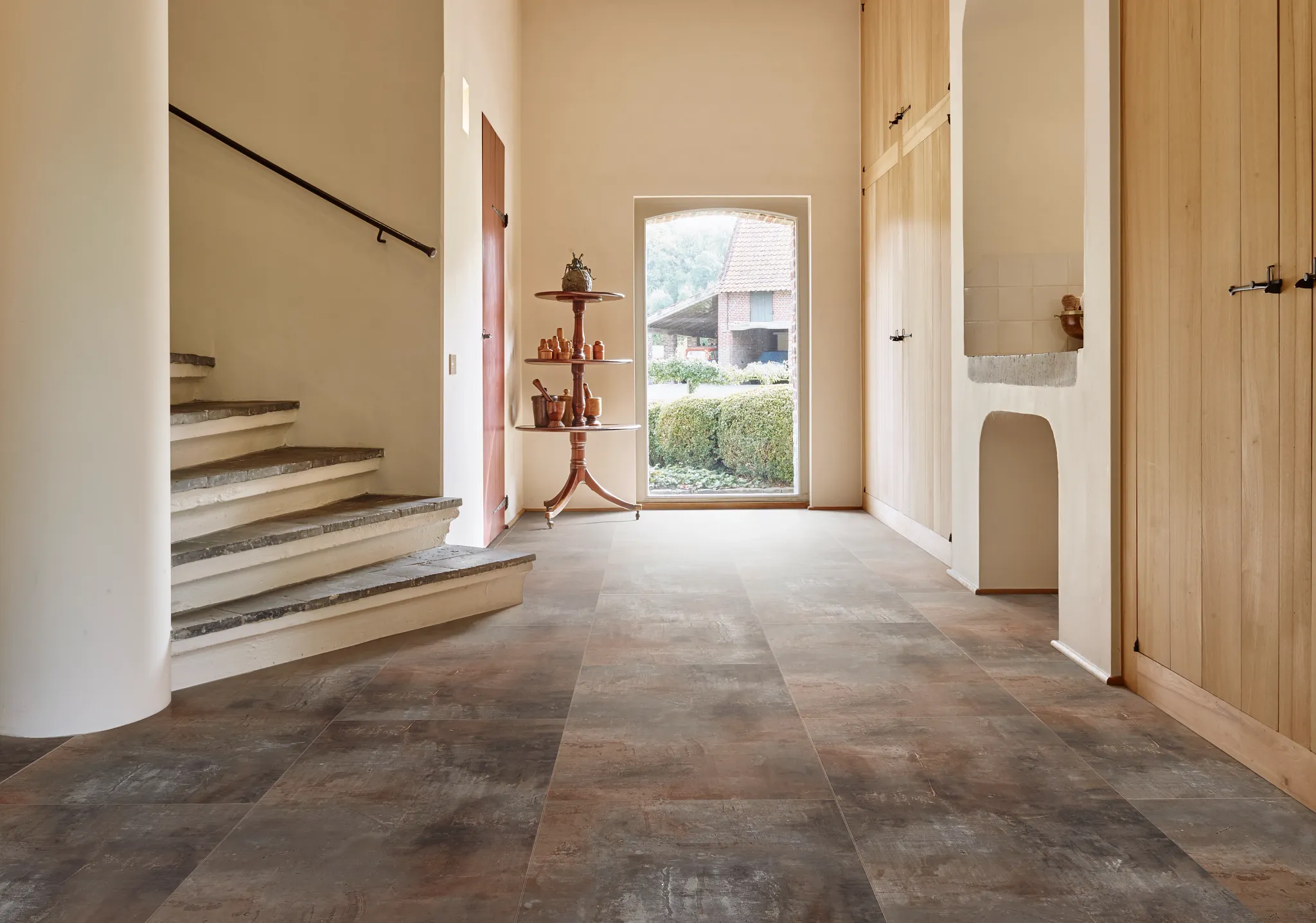 Modern hallway with stone look luxury vinyl tile flooring in shades of brown and gray