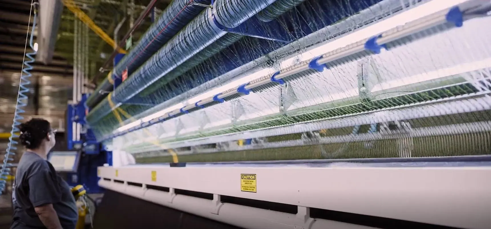 Industrial carpet weaving machine in operation