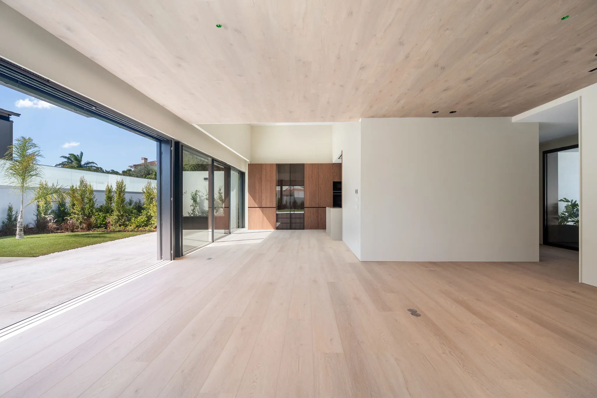 Modern kitchen and living room with Coretec floors and ceiling 