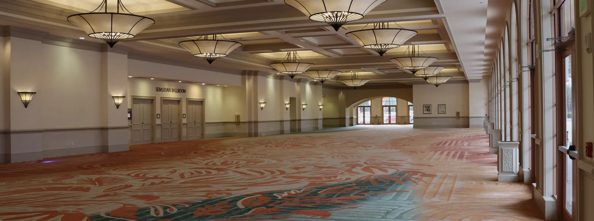 Spacious ballroom with patterned carpet flooring