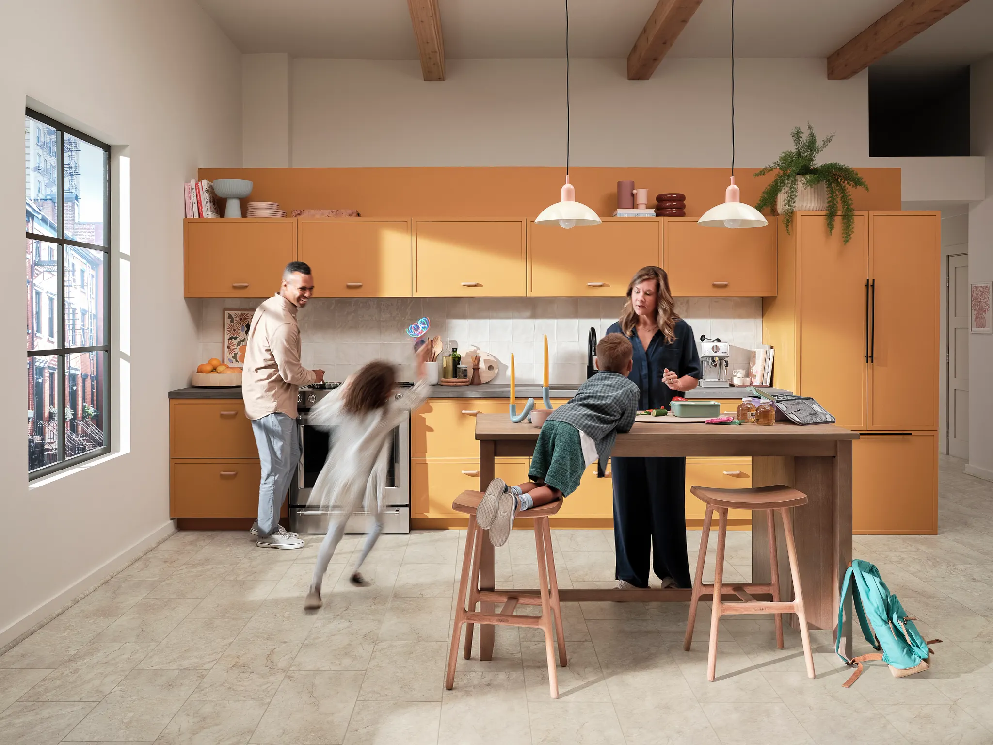kitchen with luxury vinyl tile floor in a light stone look with a family interacting around a kitchen island