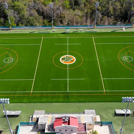 Artificial Turf Sports Field with Soccer and Basketball Courts. Aerial view of a sports field with artificial turf featuring soccer and basketball courts