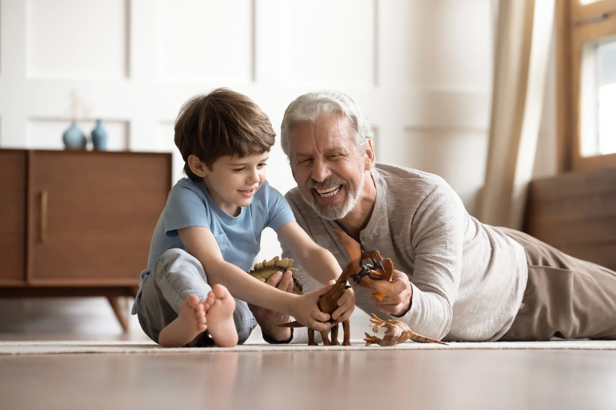 Shaw Builder SF Grandfarther and boy sitting on Mariner Oak flooring playing