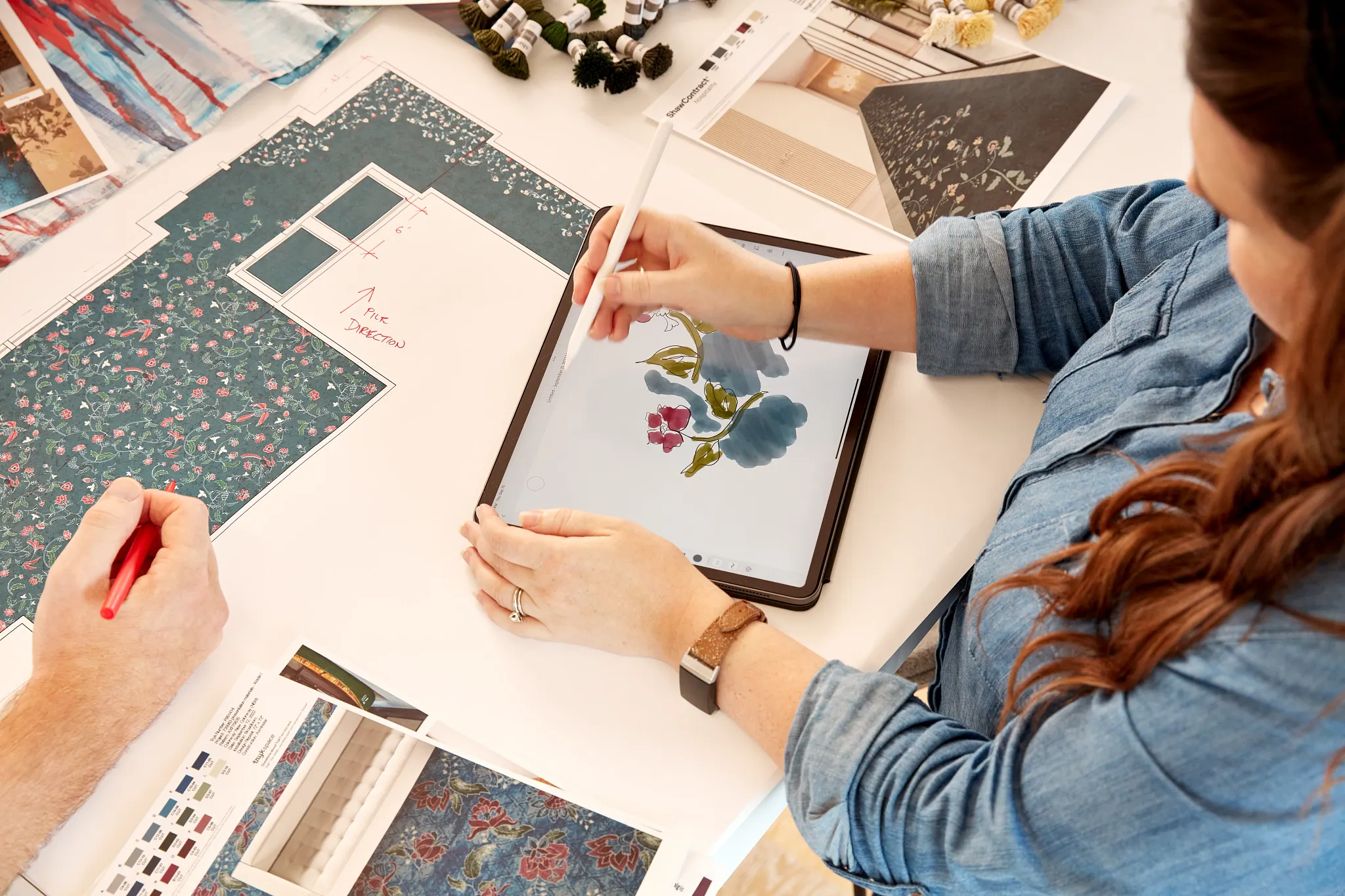 Designers collaborating on floral pattern designs for commercial carpet tile