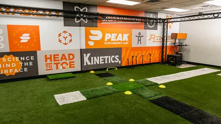 Artificial Turf in Indoor Training Facility Indoor training facility with artificial turf and motivational wall graphics