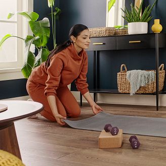 woman on a yoga mat exercising on coretec vinyl flooring