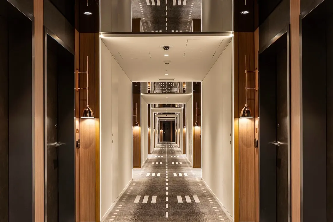 Modern hotel corridor with patterned carpet flooring