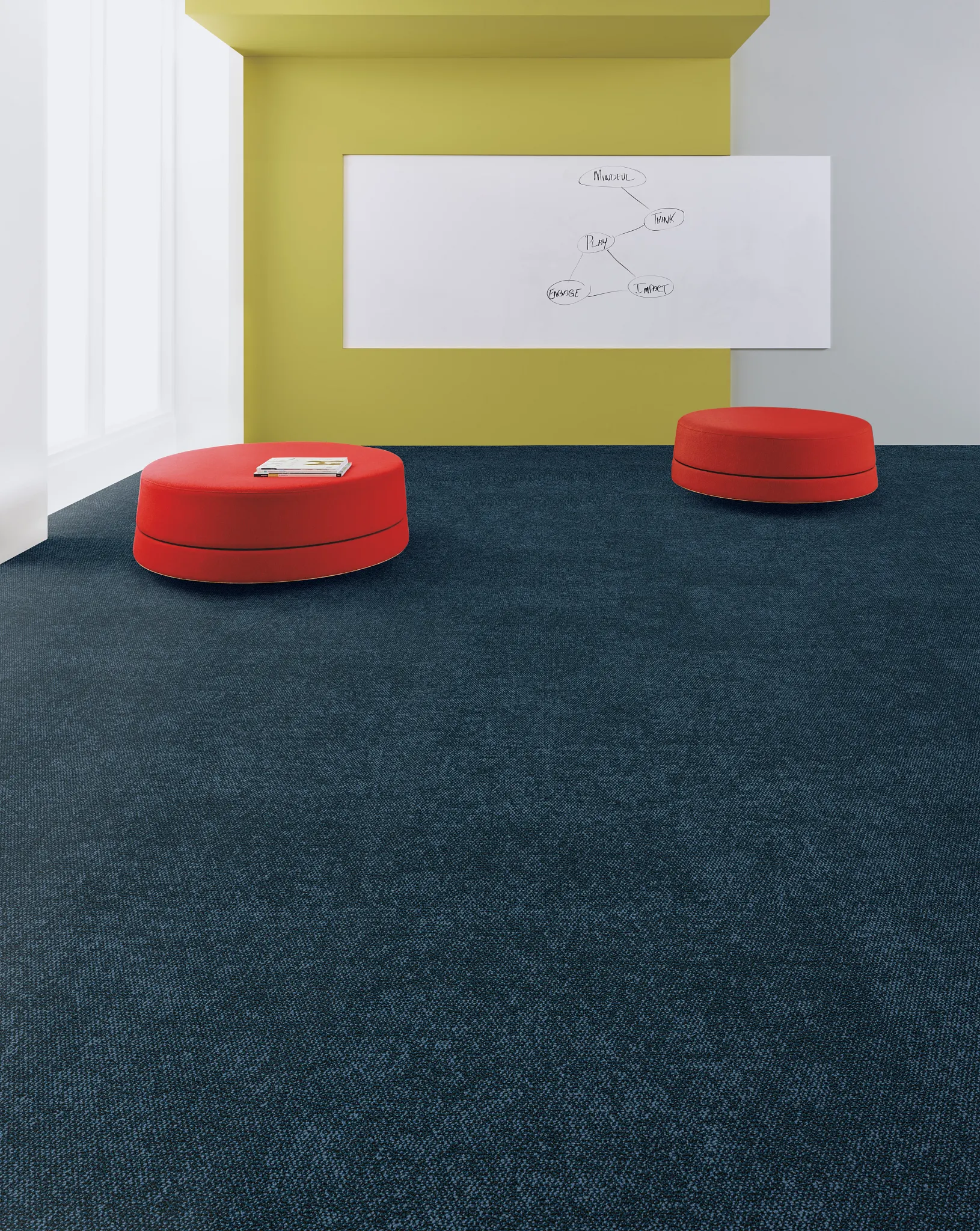 Modern education facility with dark blue commercial carpet tile and red seating
