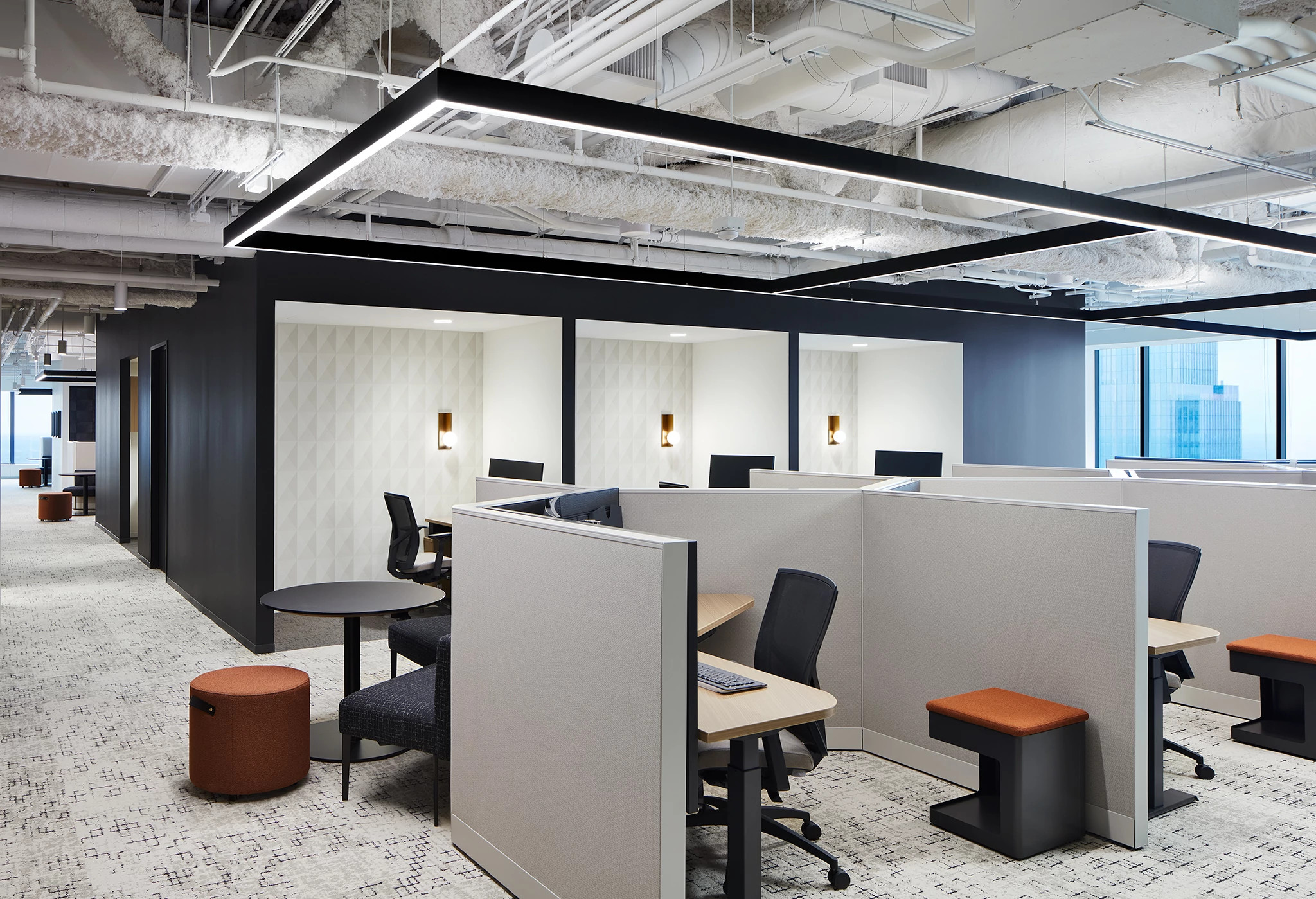 Modern office workspace with cubicles and commercial carpet flooring