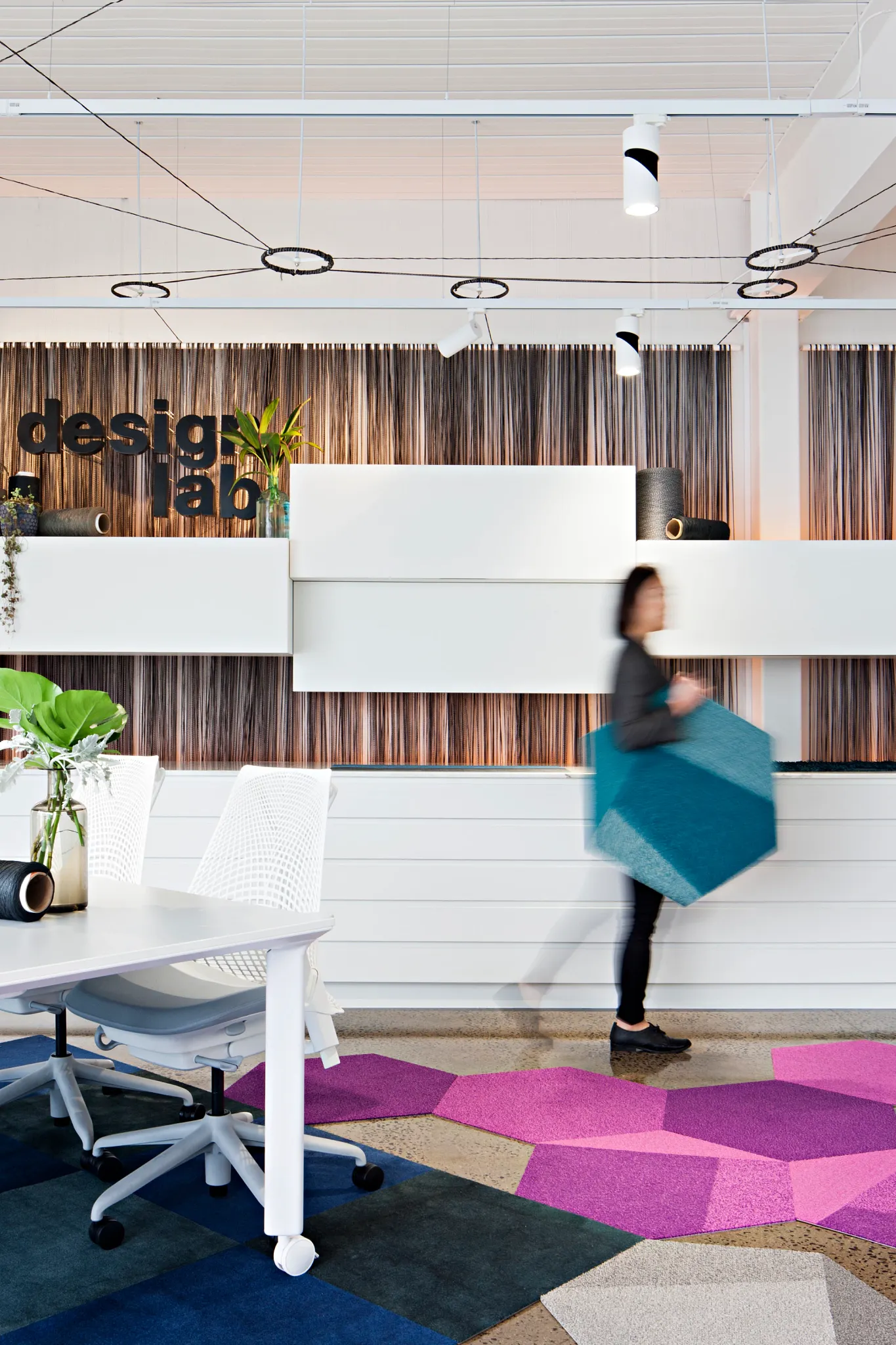 Modern design lab with colorful geometric carpet tiles