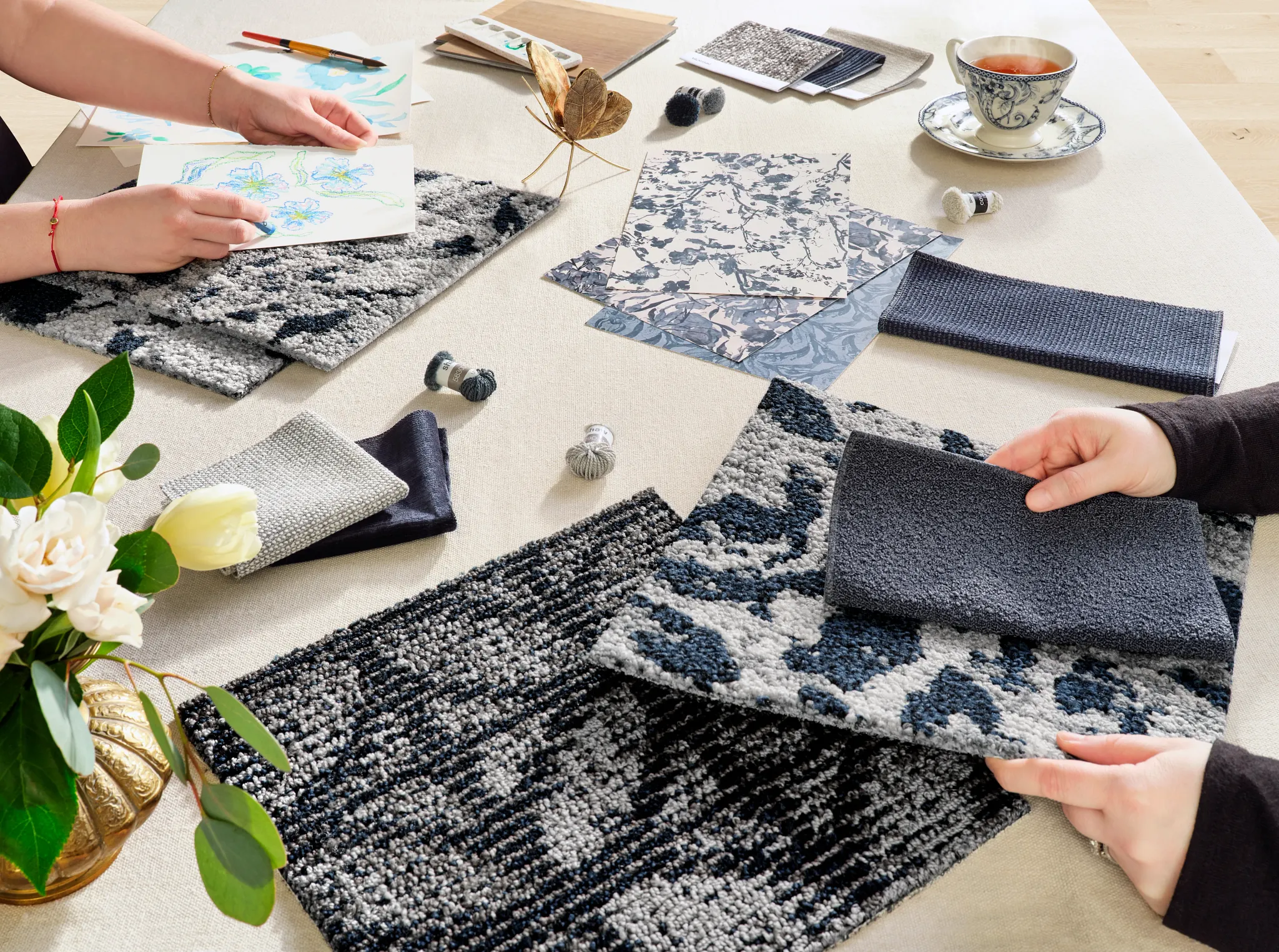 Assorted carpet swatches in blue, gray, and black with design sketches