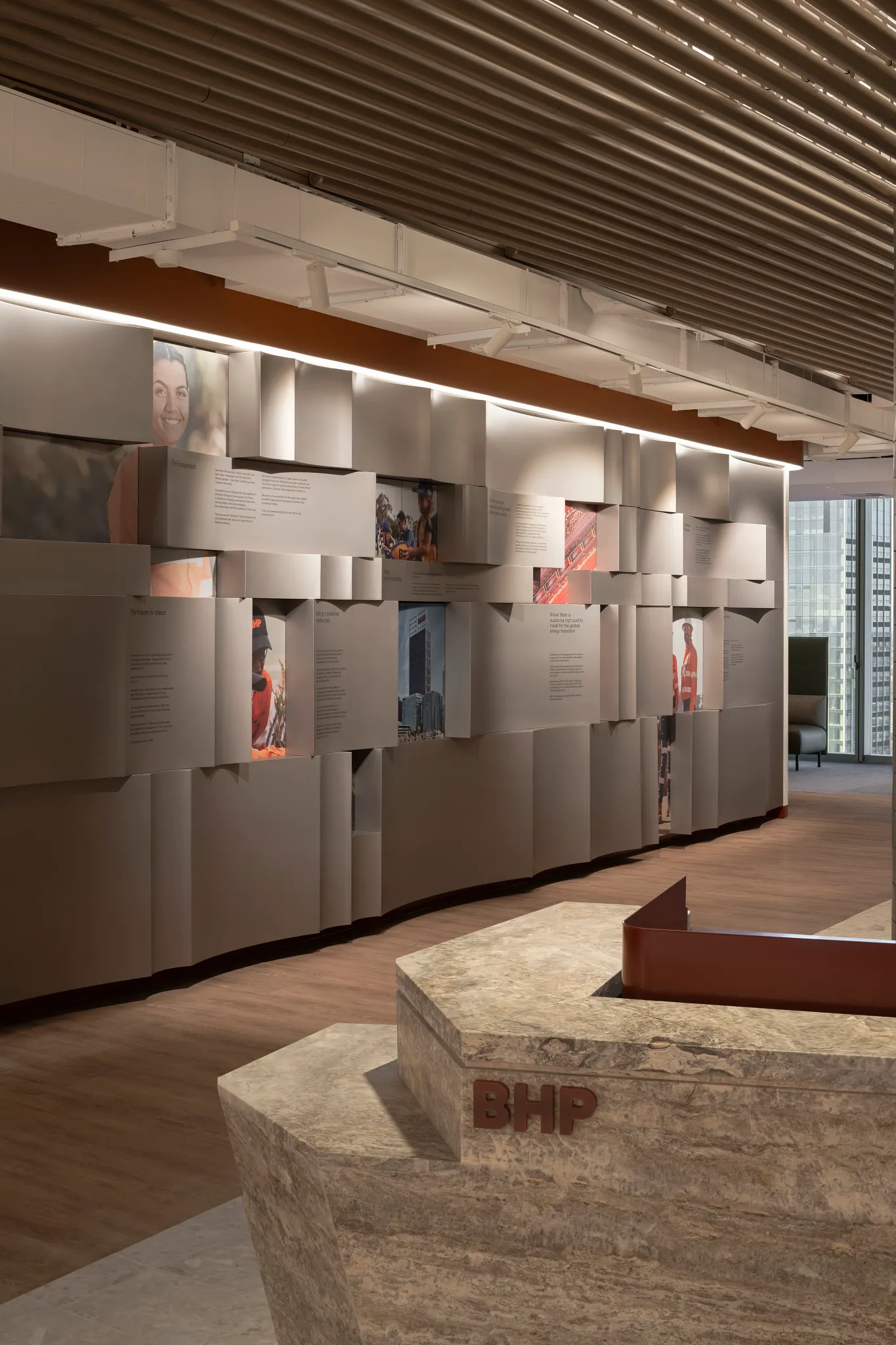 Modern office interior with wood flooring and textured wall panels