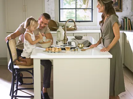 Light hardwood flooring for a warm and inviting kitchen atmosphere Family enjoying time in a cozy kitchen with light hardwood flooring