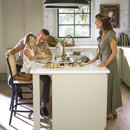 Light hardwood flooring for a warm and inviting kitchen atmosphere Family enjoying time in a cozy kitchen with light hardwood flooring