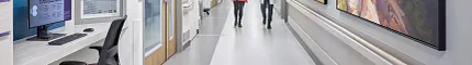 Healthcare Facility Hallway with Commercial Flooring Healthcare facility hallway with commercial flooring, featuring a doctor and a woman walking