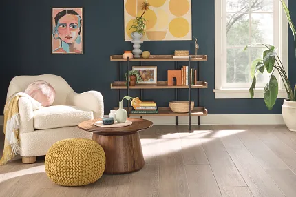 Light Wood Look Luxury Vinyl Plank Flooring in Modern Living Room Scene living room with luxury vinyl plank floor in a light wood look with a armchair wooden coffee table and decorative plants