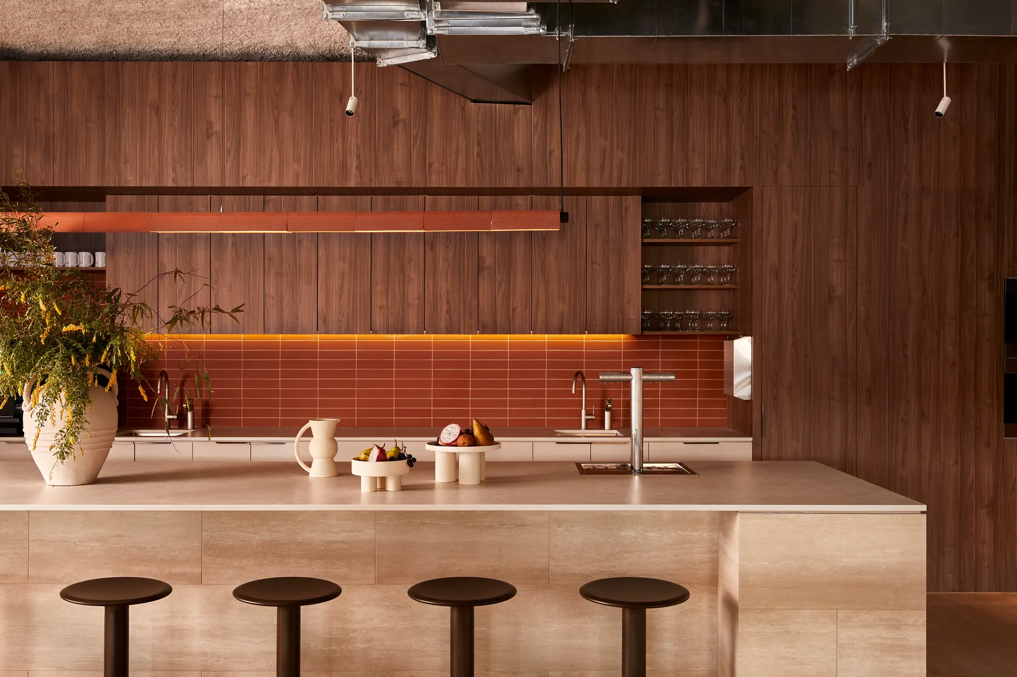 Modern kitchen with wood paneling and bar stools