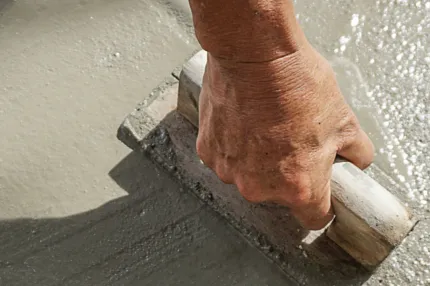 Professional concrete floor installation technique Hand smoothing concrete flooring surface