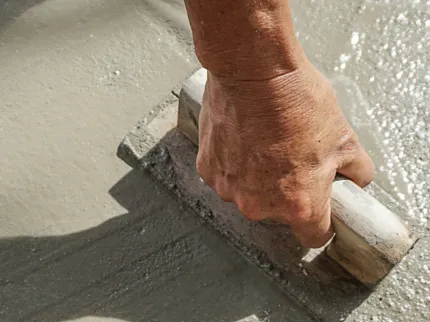 Professional concrete floor installation technique Hand smoothing concrete flooring surface