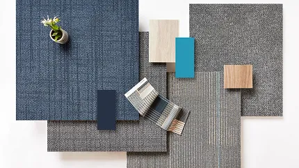 Commercial Carpet Tile Swatch in Blue, Grey, and Beige Colors Swatch of commercial carpet tiles in various colors including blue, grey, and beige with a small plant on top